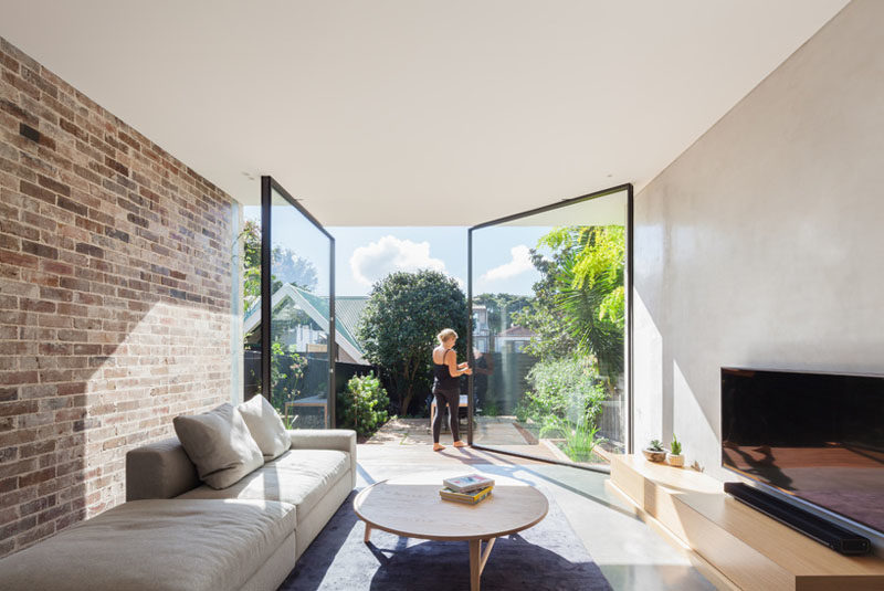 The Back Wall Of This Home Is Made From Two Large Pivoting Glass Doors 1