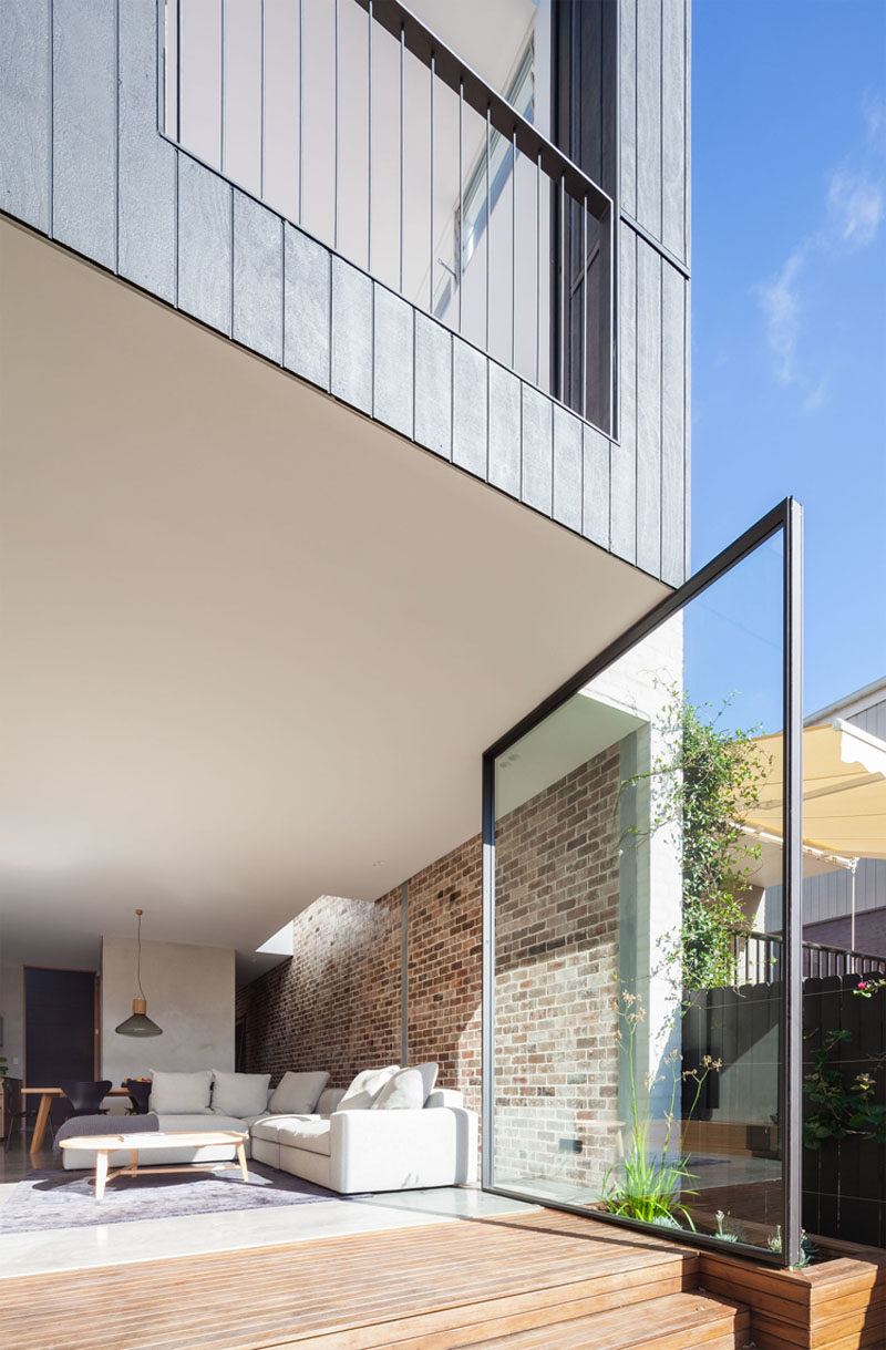 The Back Wall Of This Home Is Made From Two Large Pivoting Glass Doors 4